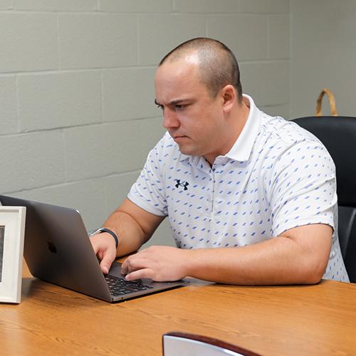 adult student on computer in office